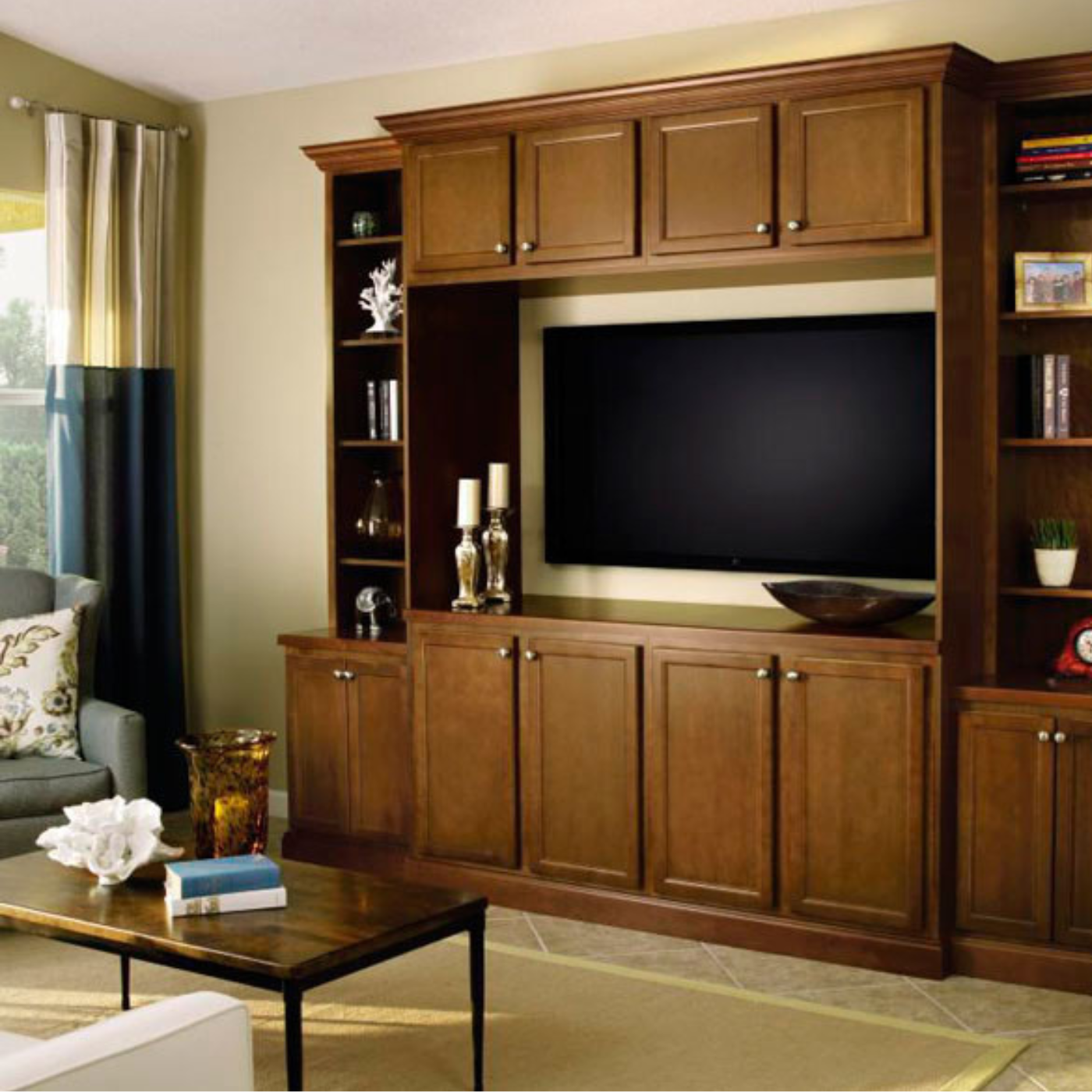 A living room with wooden cabinets and a flat screen tv
