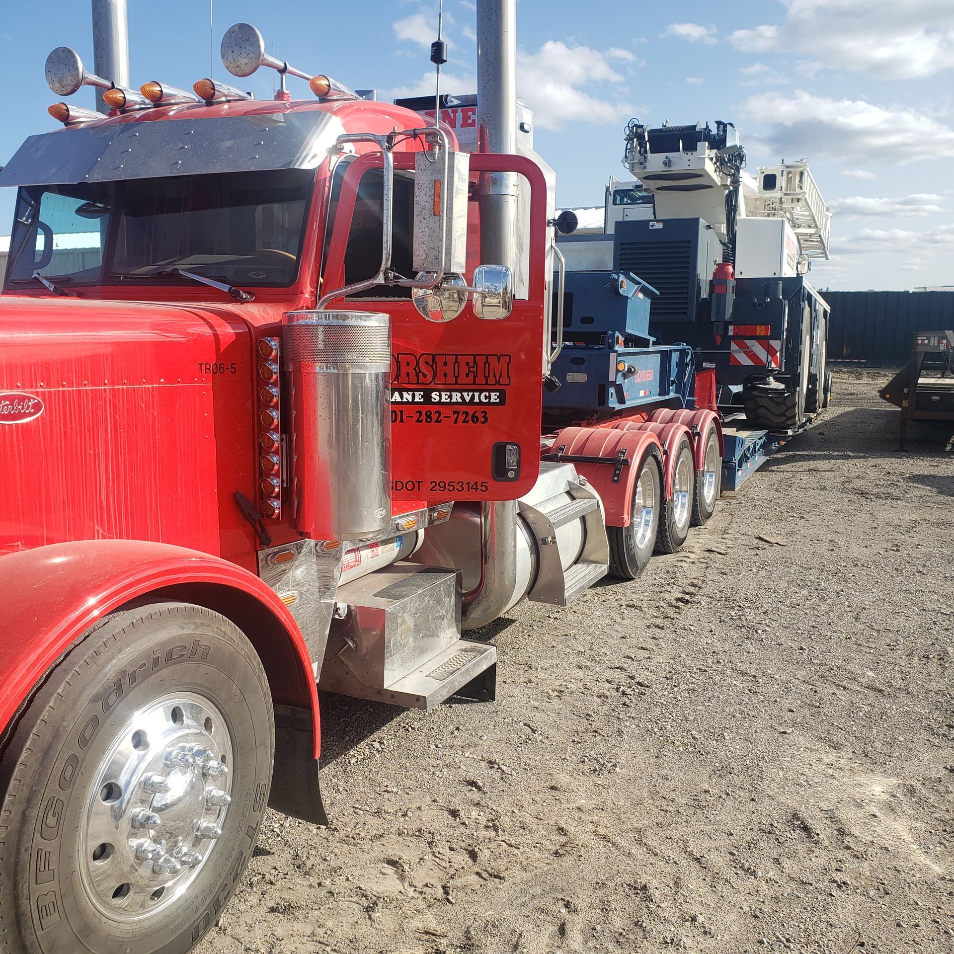 Red truck transporting machinery