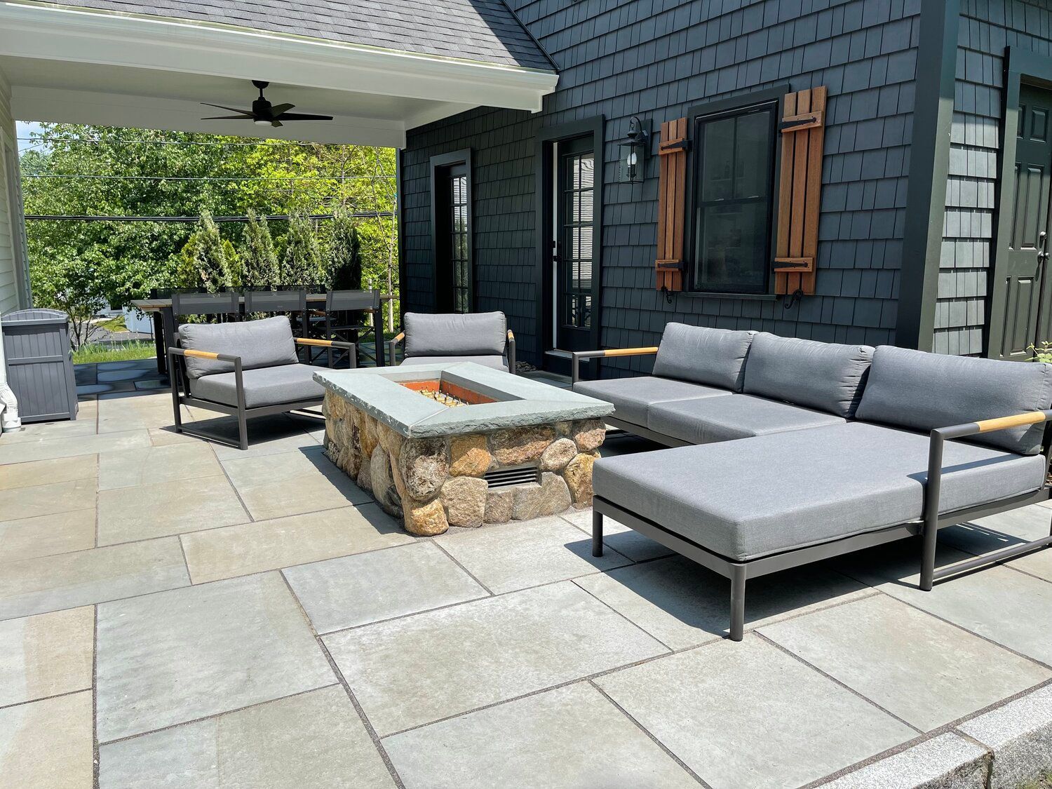 There is a fire pit in the middle of the patio.