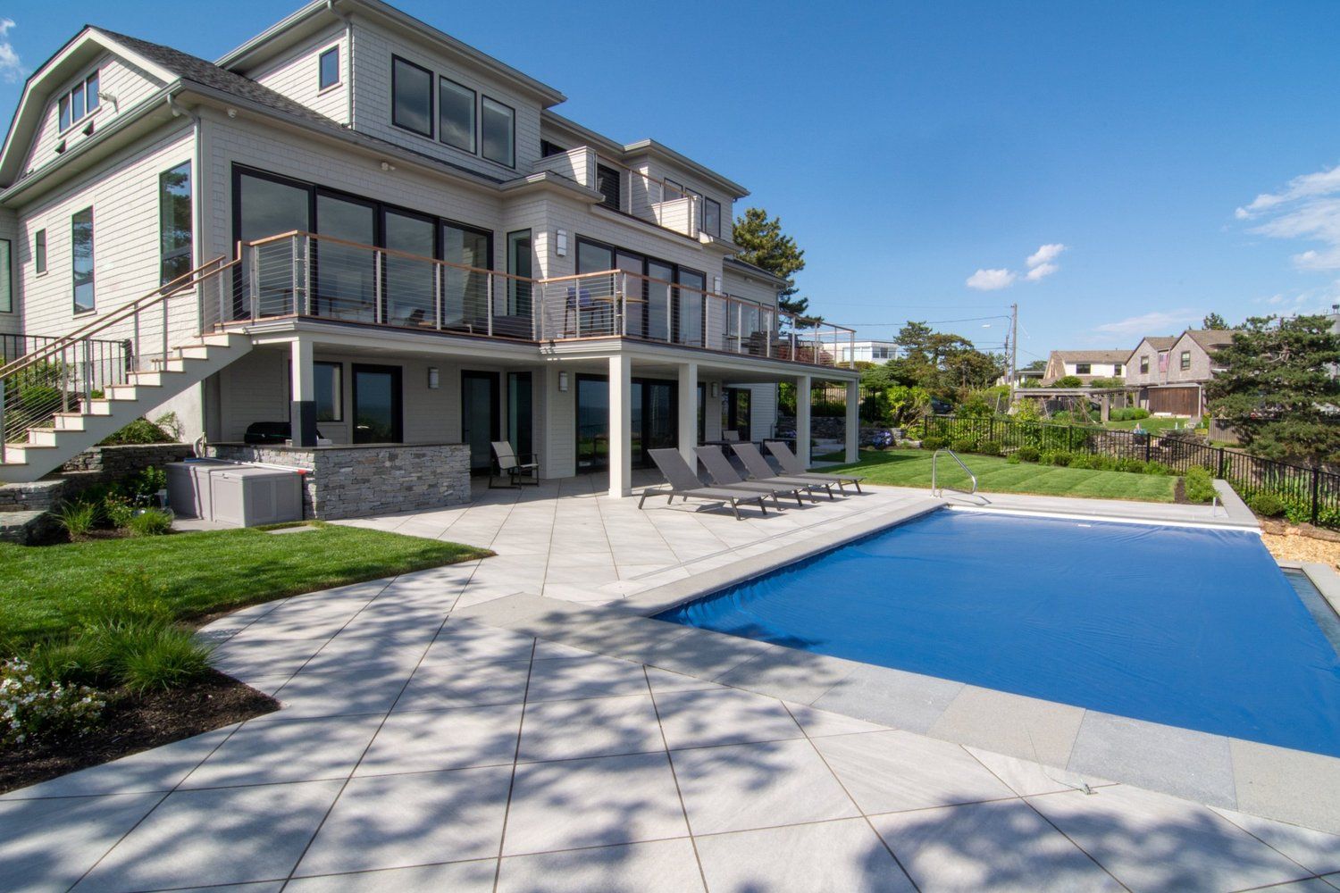 A large house with a large swimming pool in front of it.