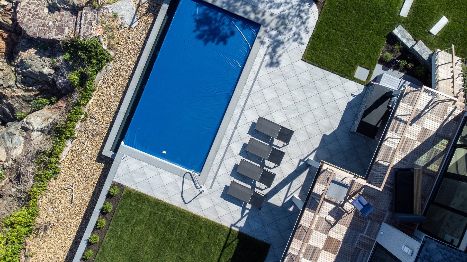 An aerial view of a swimming pool in a backyard.