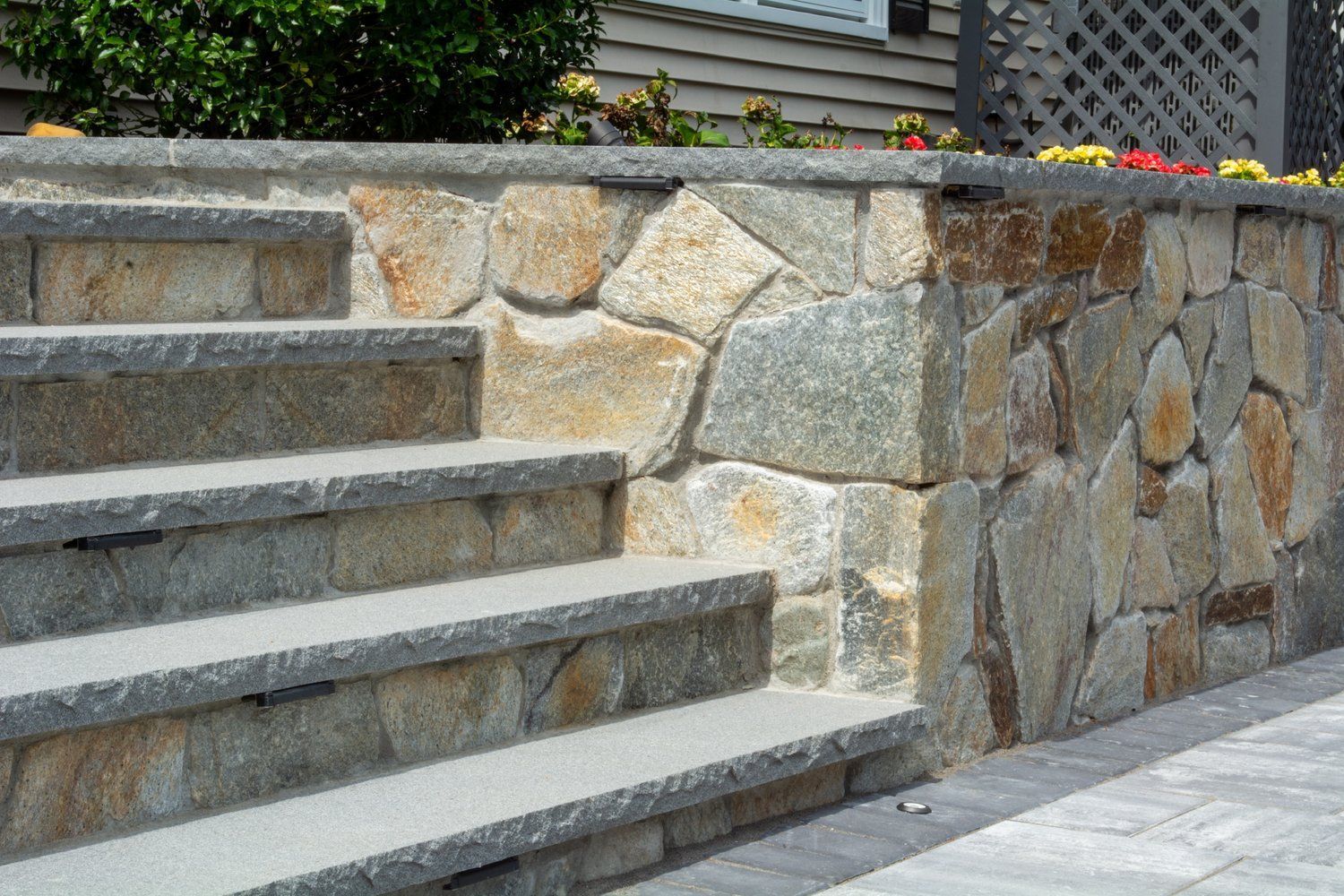 A stone wall with stairs leading up to it