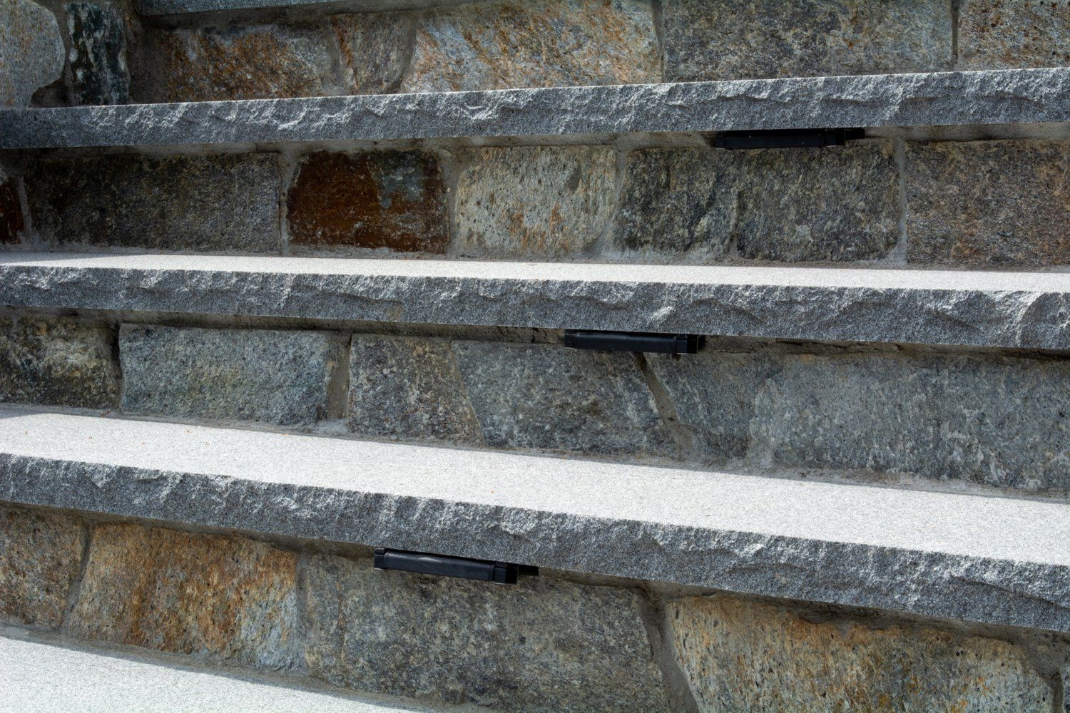 A close up of a set of stairs made of stone.