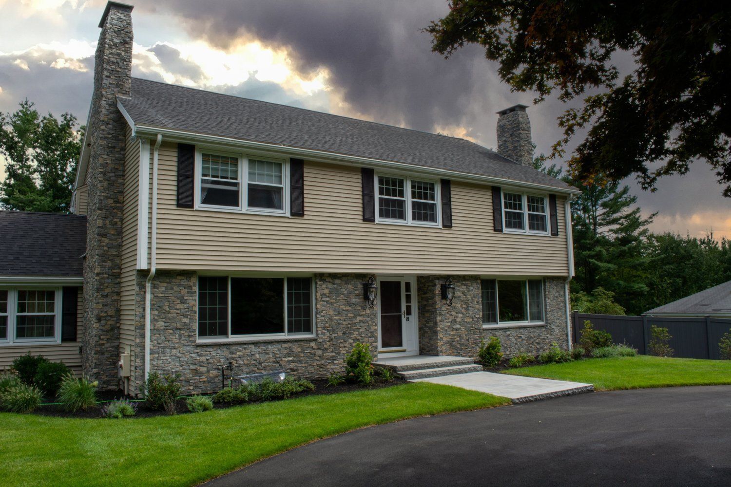 A large house with a lot of windows and a chimney