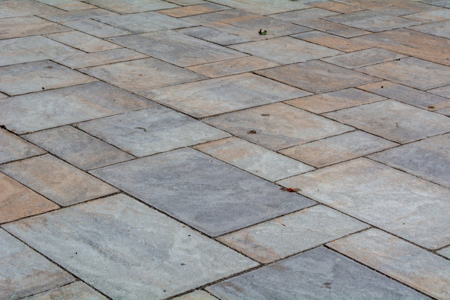 A close up of a brick floor with a diagonal pattern