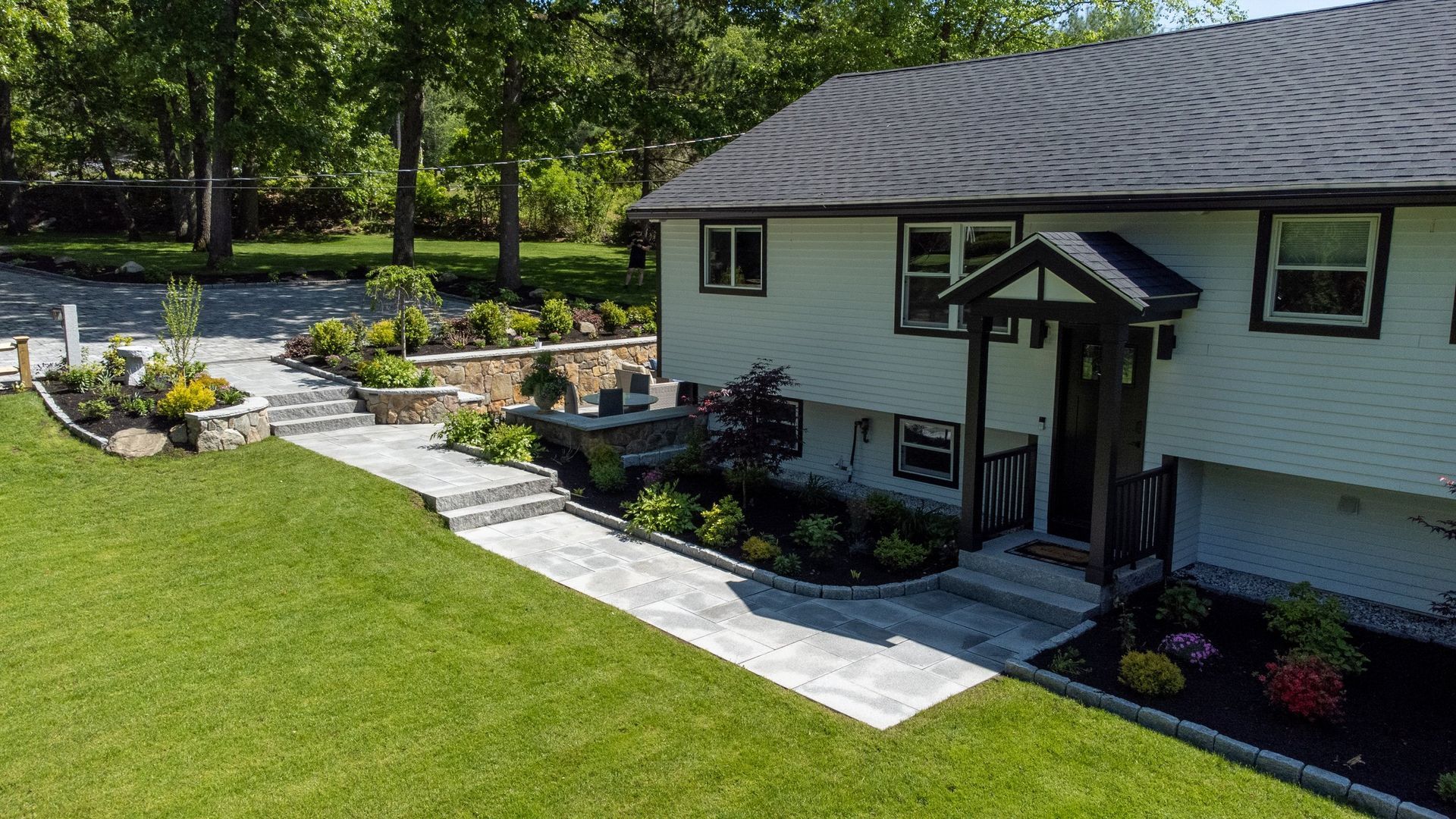 An aerial view of a house with a walkway leading to the front door.