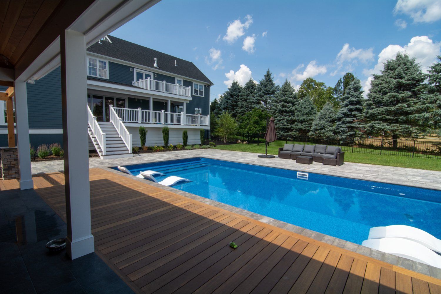 A large house with a large swimming pool in front of it