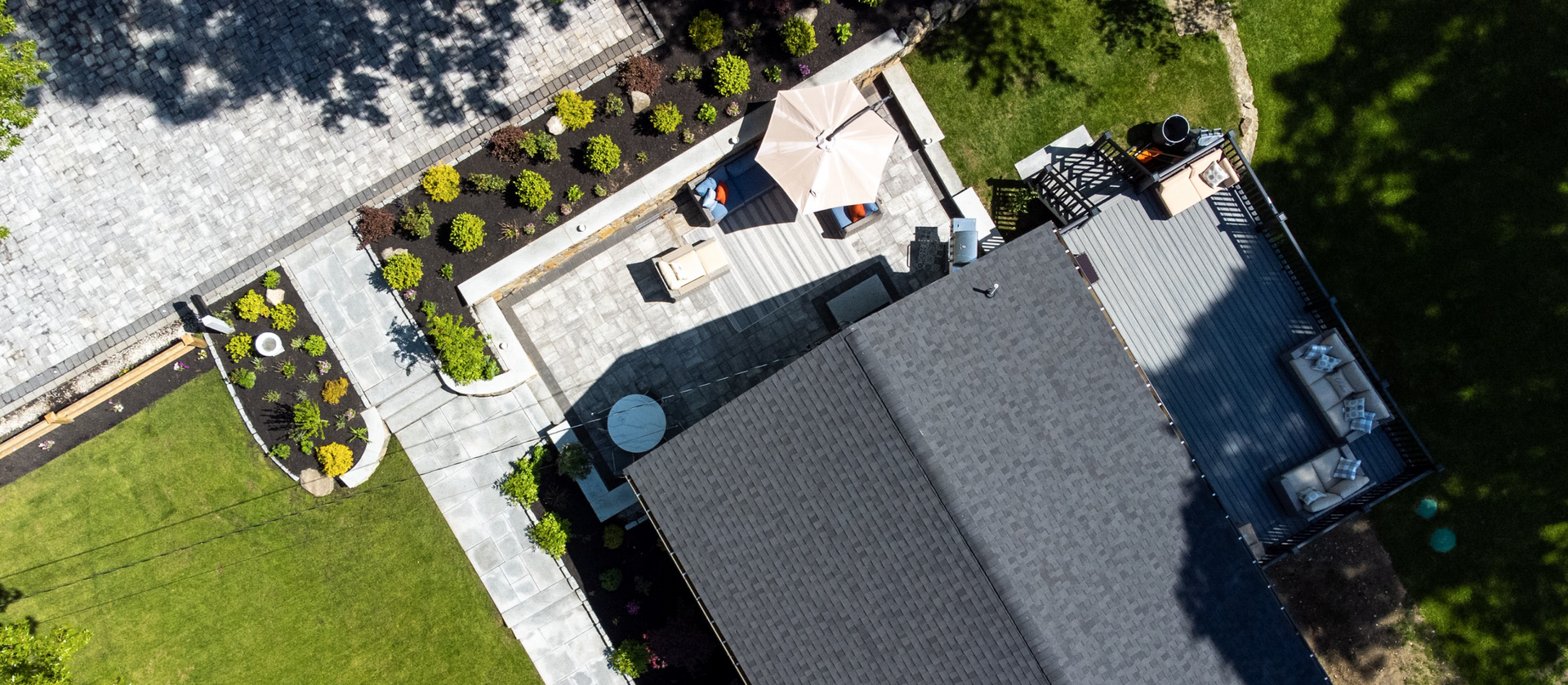 An aerial view of a house with a patio and a driveway.