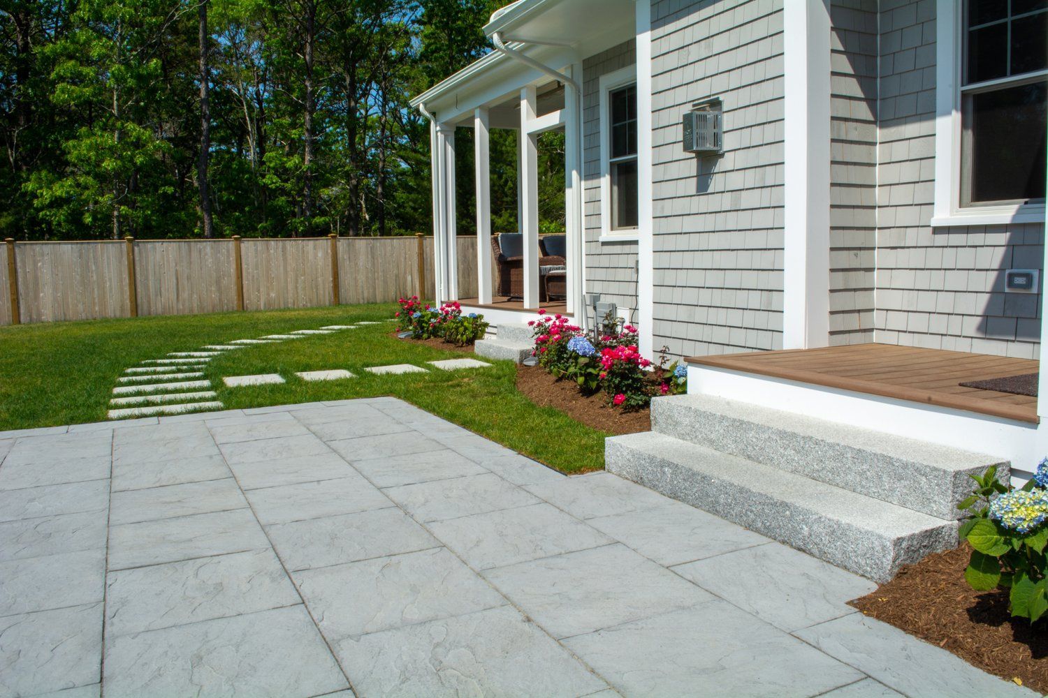A house with a patio and steps in front of it