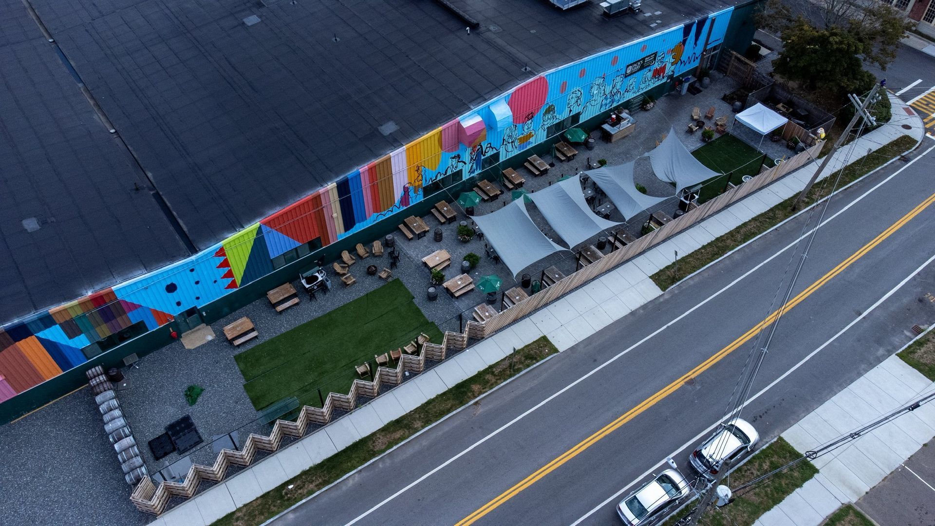 An aerial view of a building with a large mural on the side of it.