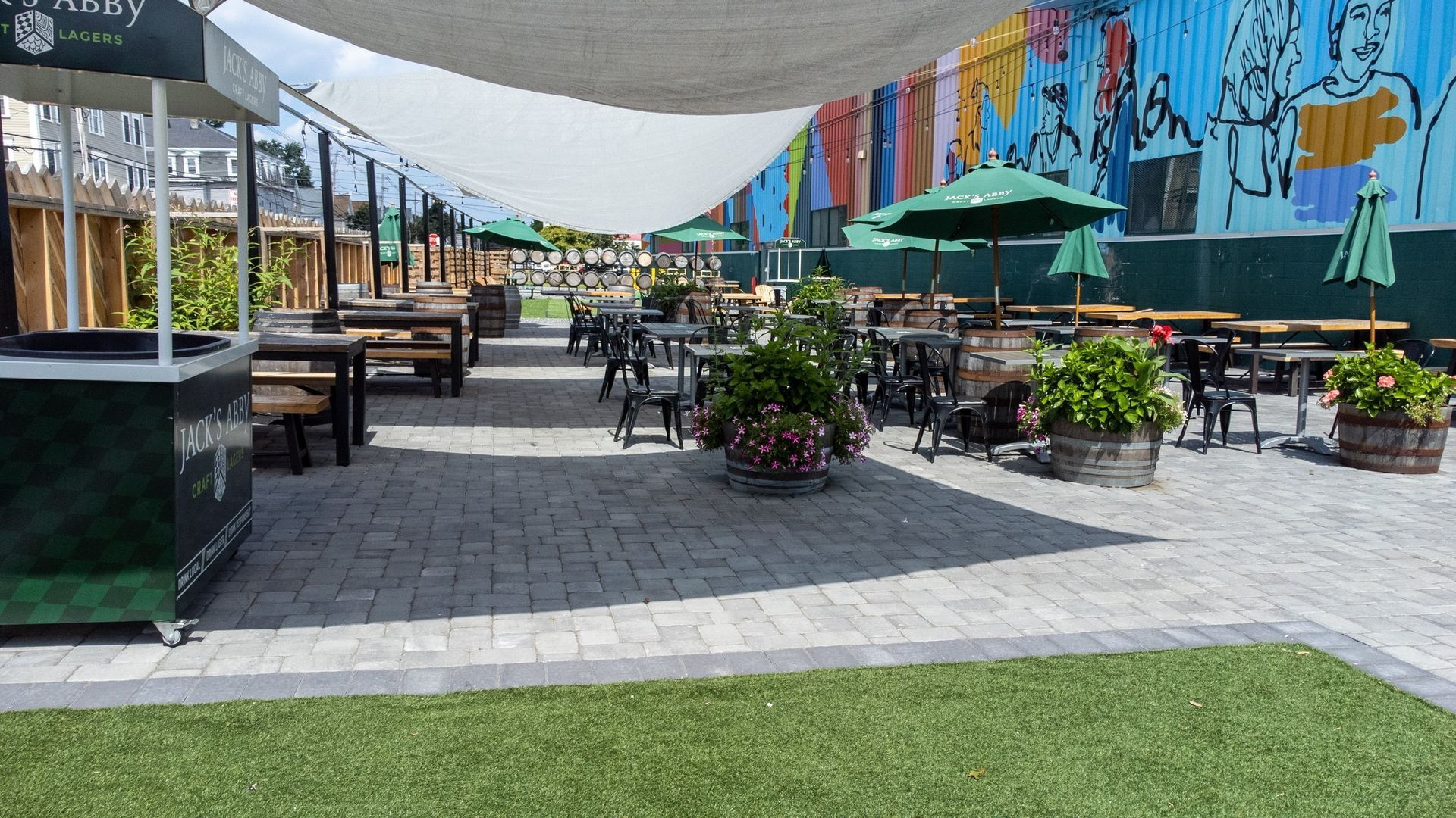 A patio area with tables and chairs and umbrellas