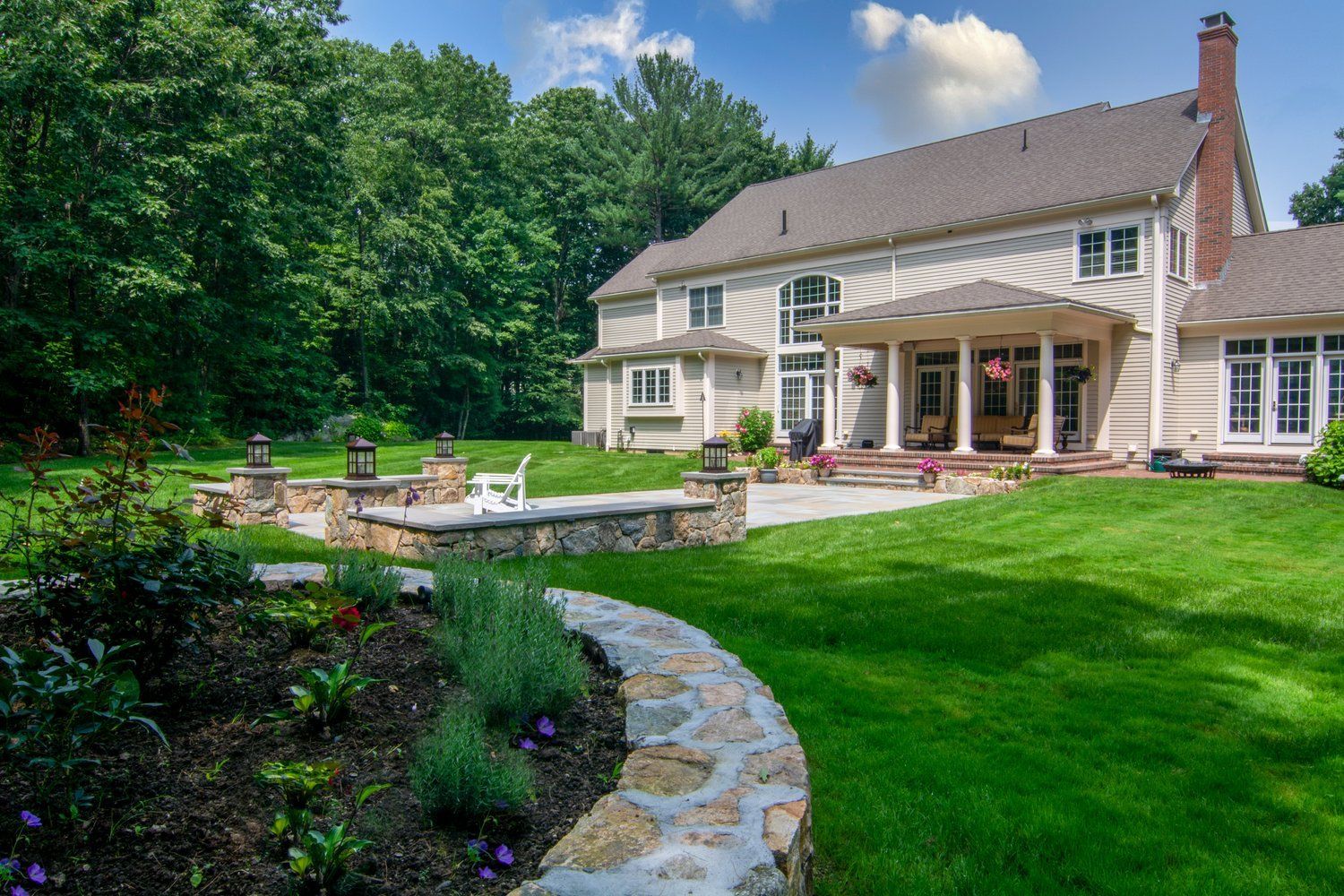 A large white house with a large lawn in front of it.