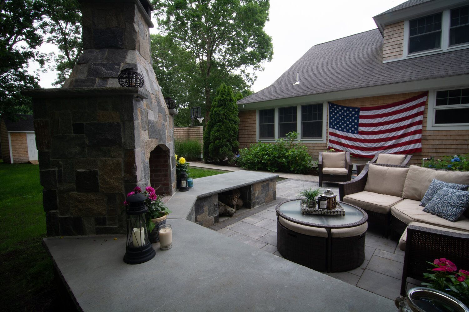 A patio with a fireplace and an american flag