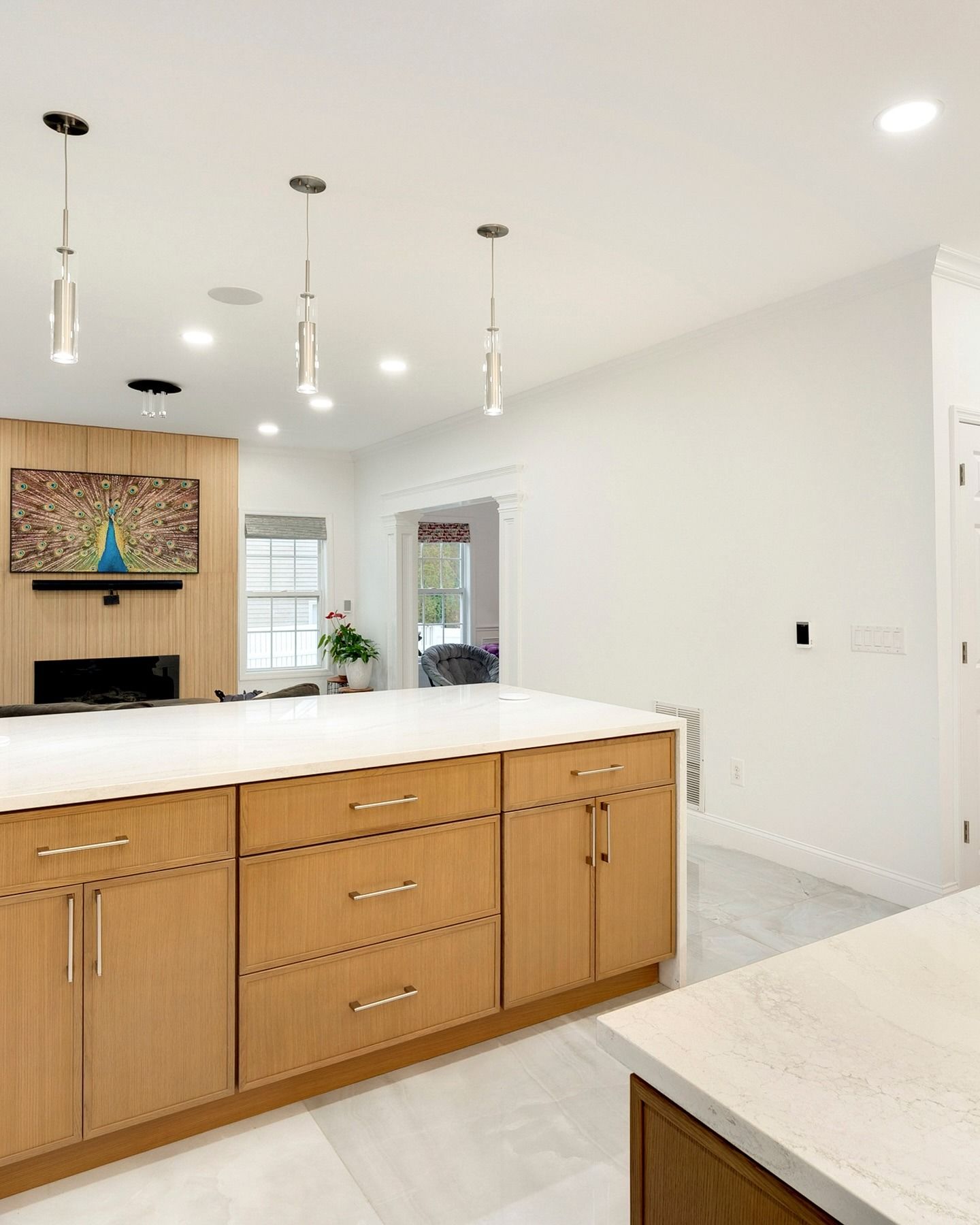 A kitchen with wooden cabinets and white counter tops