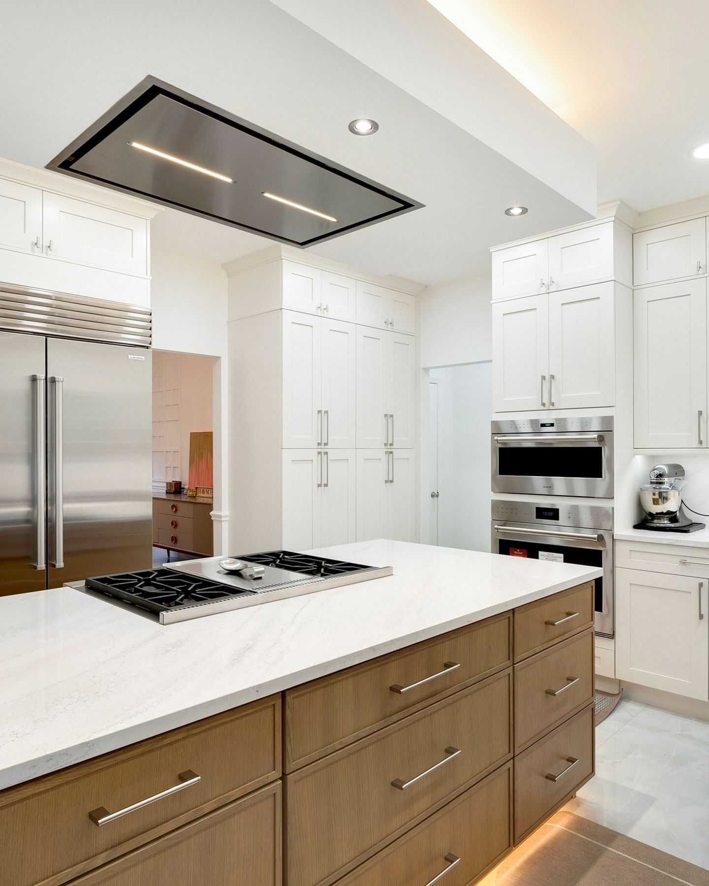A kitchen with stainless steel appliances and wooden cabinets