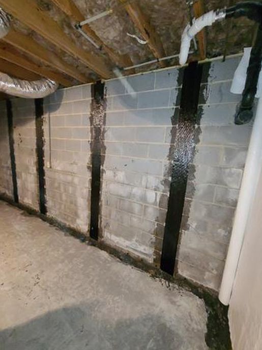 A basement with a brick wall and a ceiling