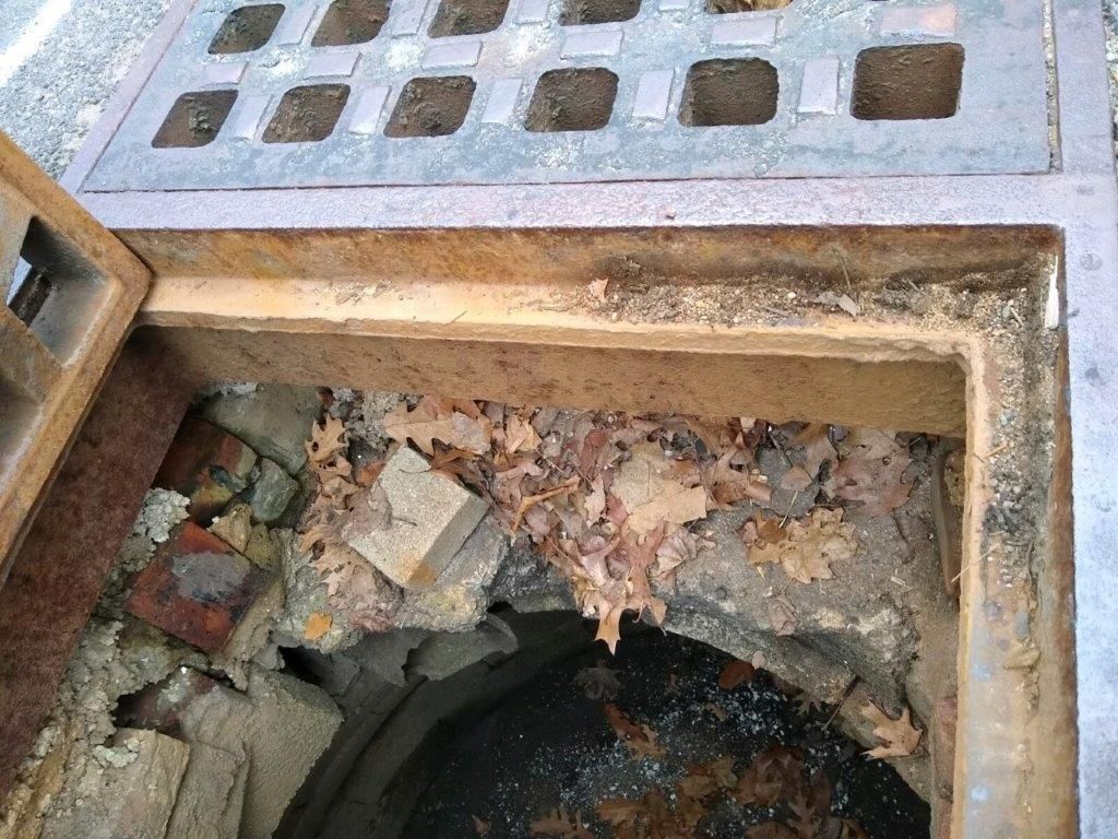 A manhole cover with a hole in the middle of it.