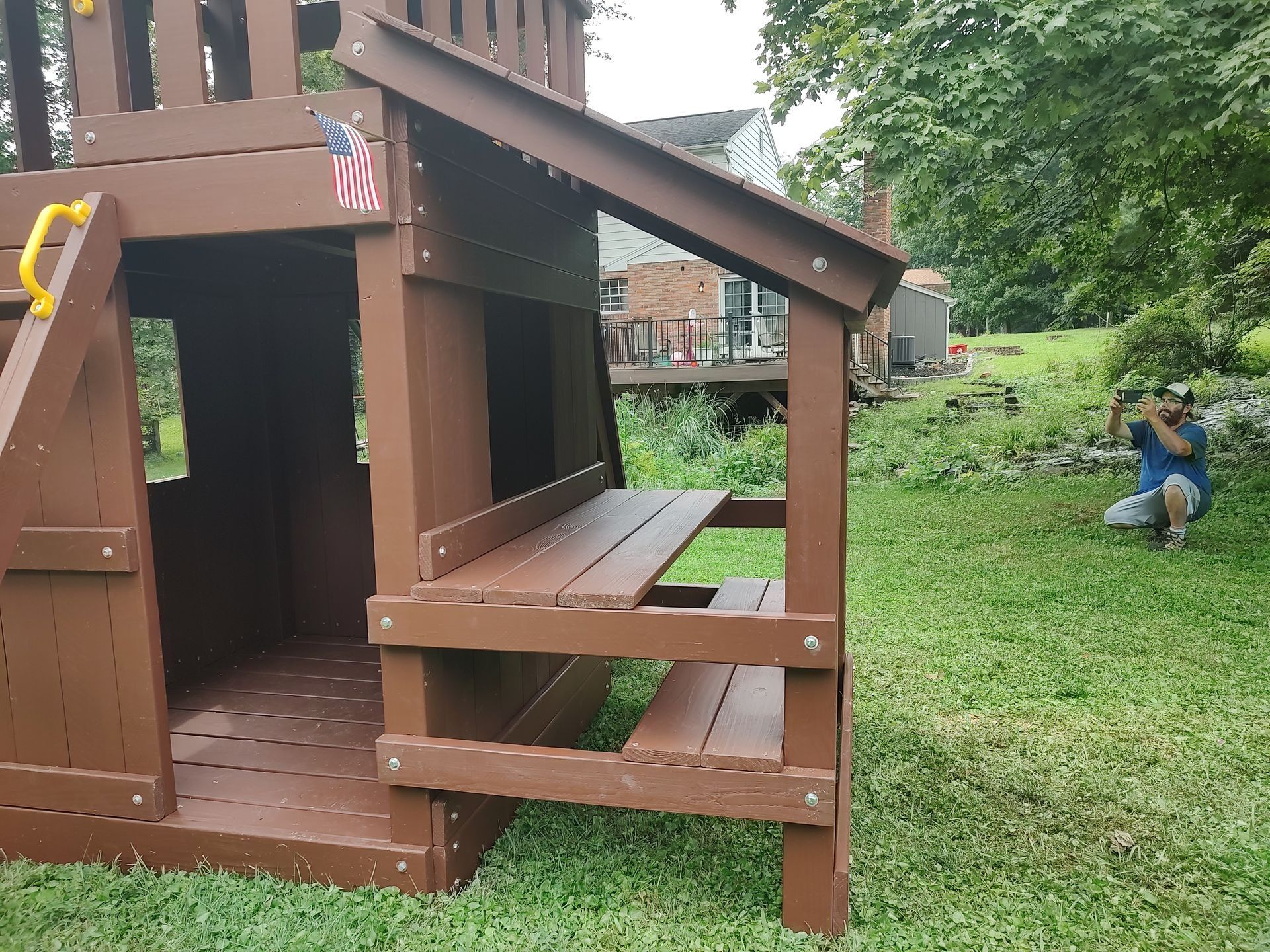Wooden backyard playset with a small bench