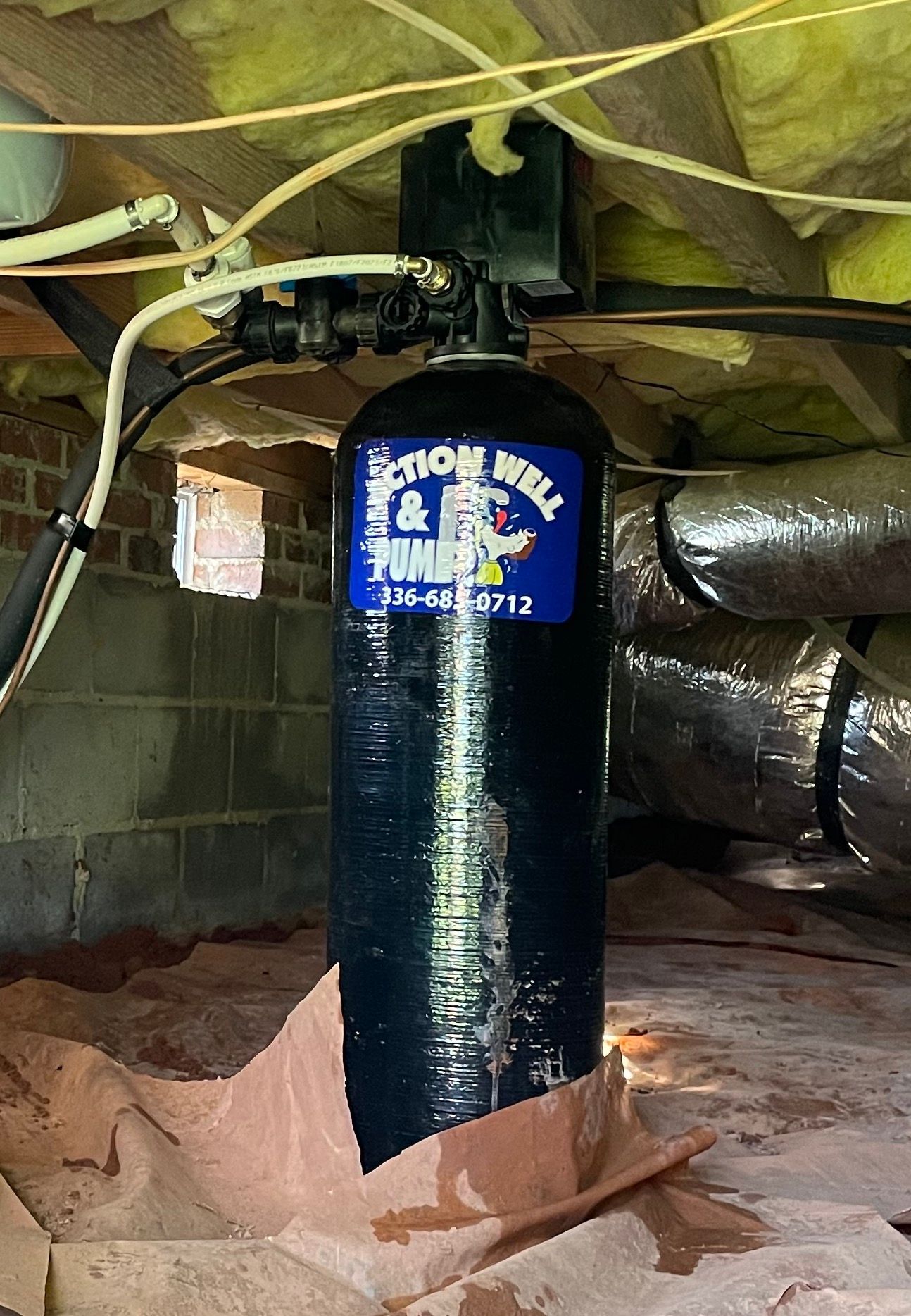 A black water treatment tank labeled 