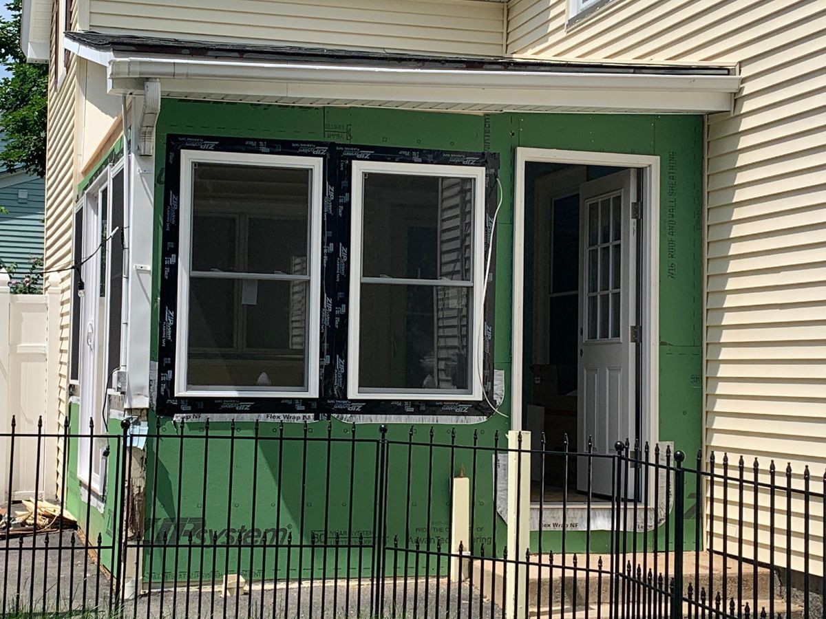 A house with a screened in porch is being remodeled.