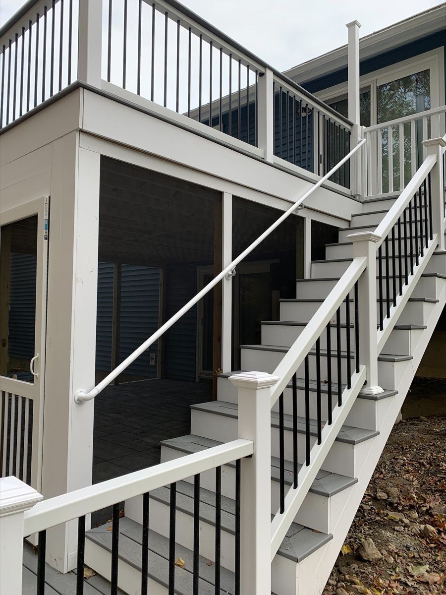 A white deck with stairs leading up to it