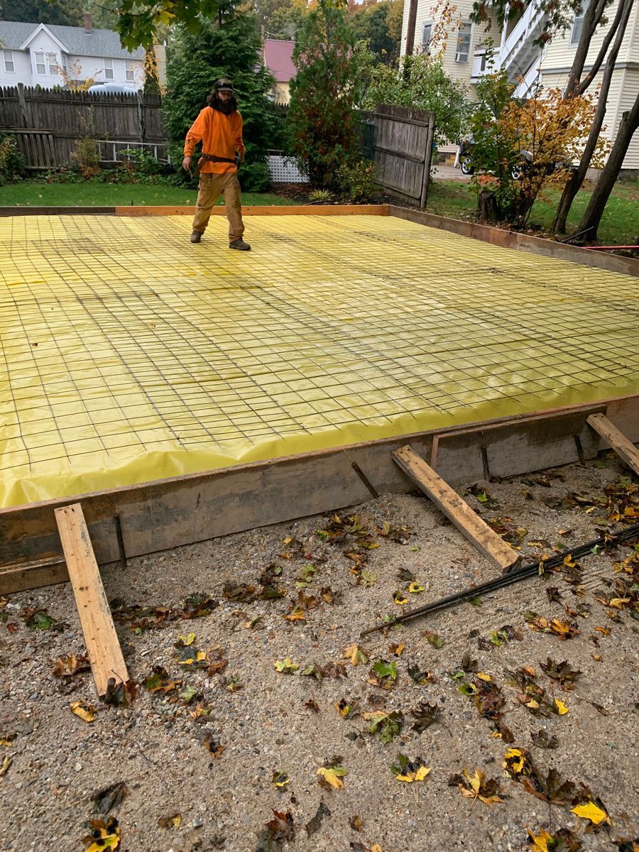 A man is standing on top of a yellow tarp.