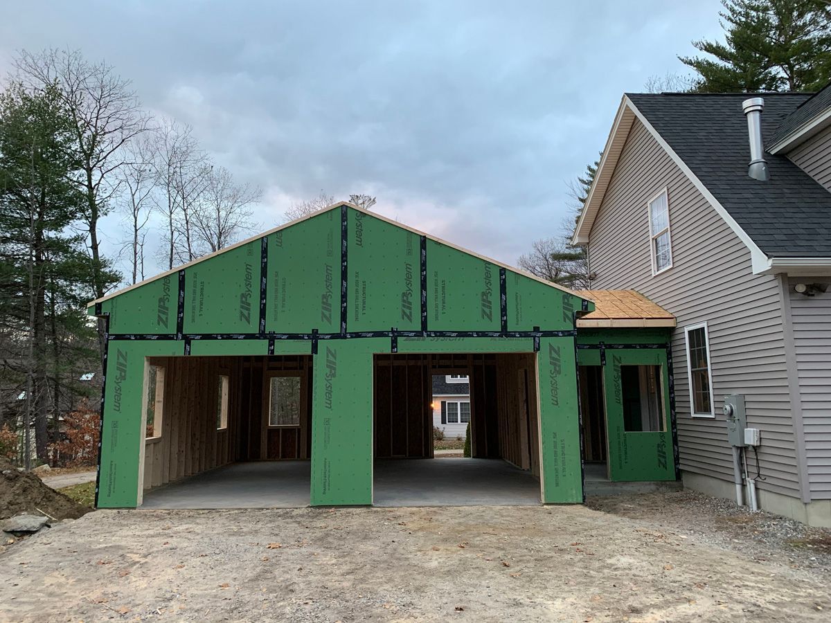 A garage is being built next to a house.