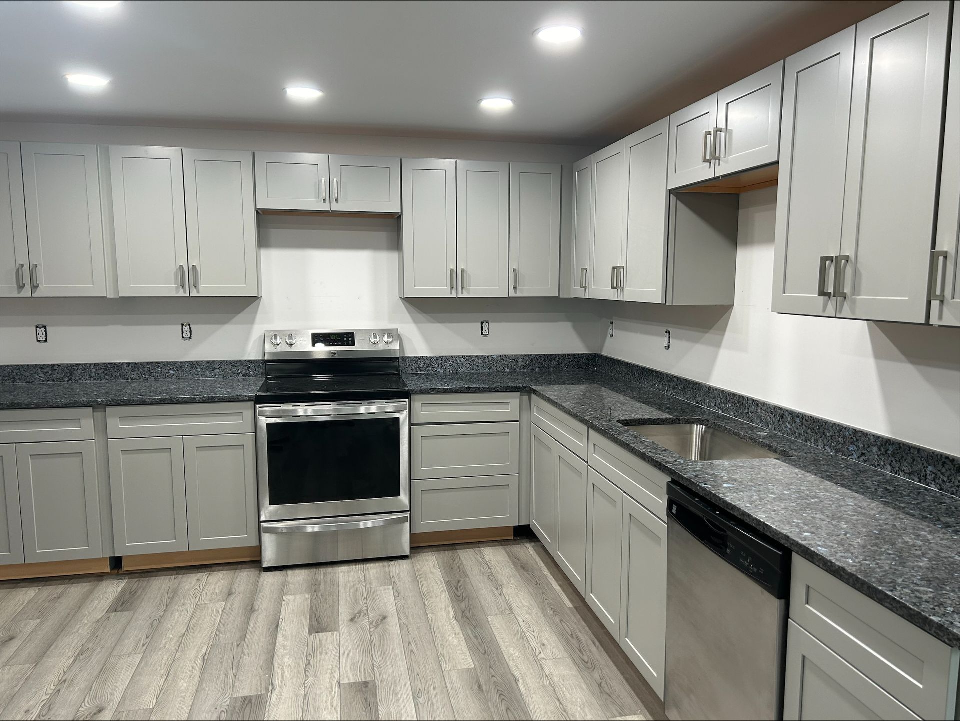 A kitchen with stainless steel appliances and granite counter tops