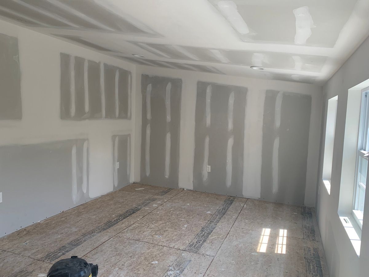 A room with a lot of drywall on the walls