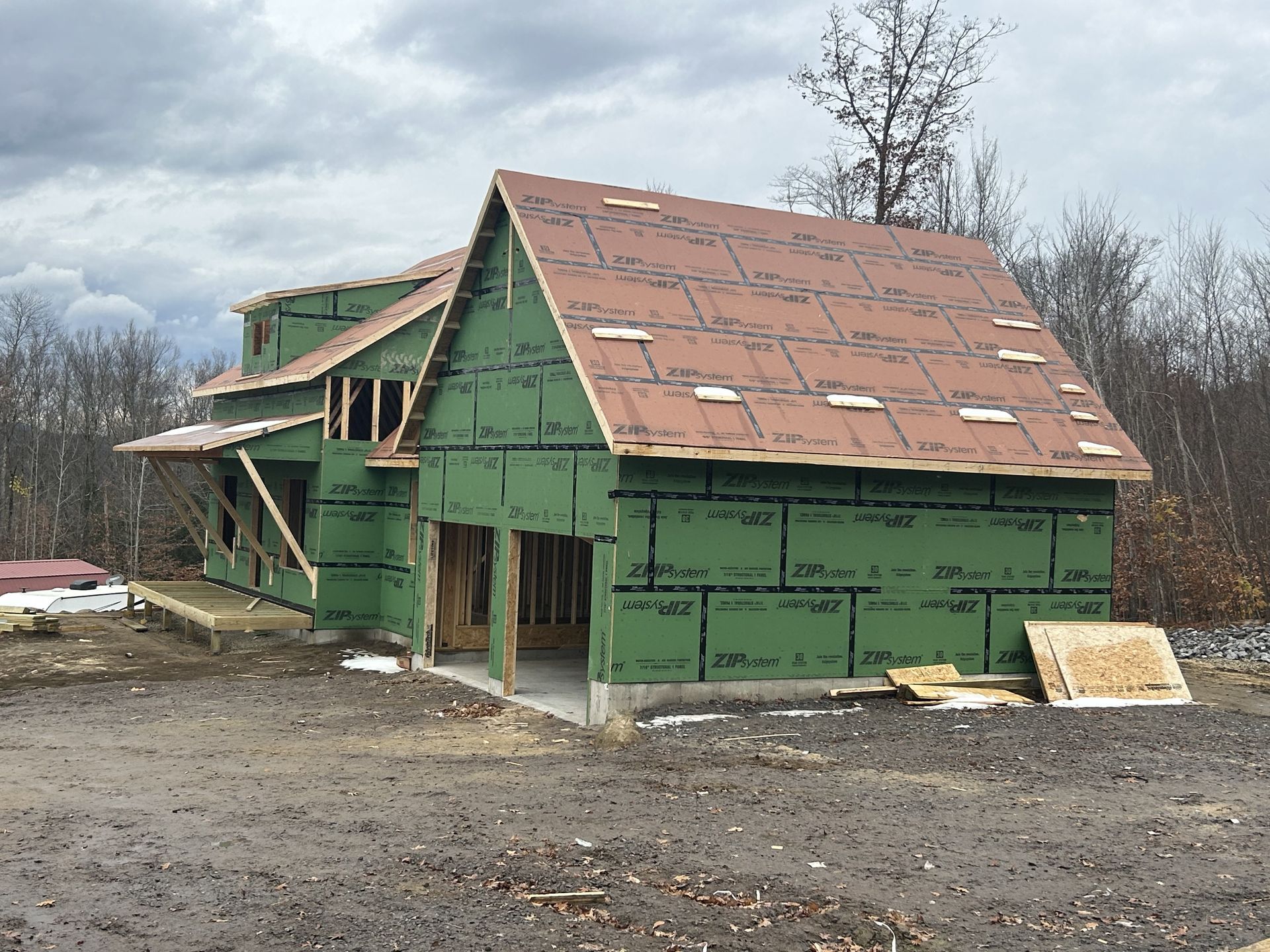 A house is being built in the middle of a dirt field.