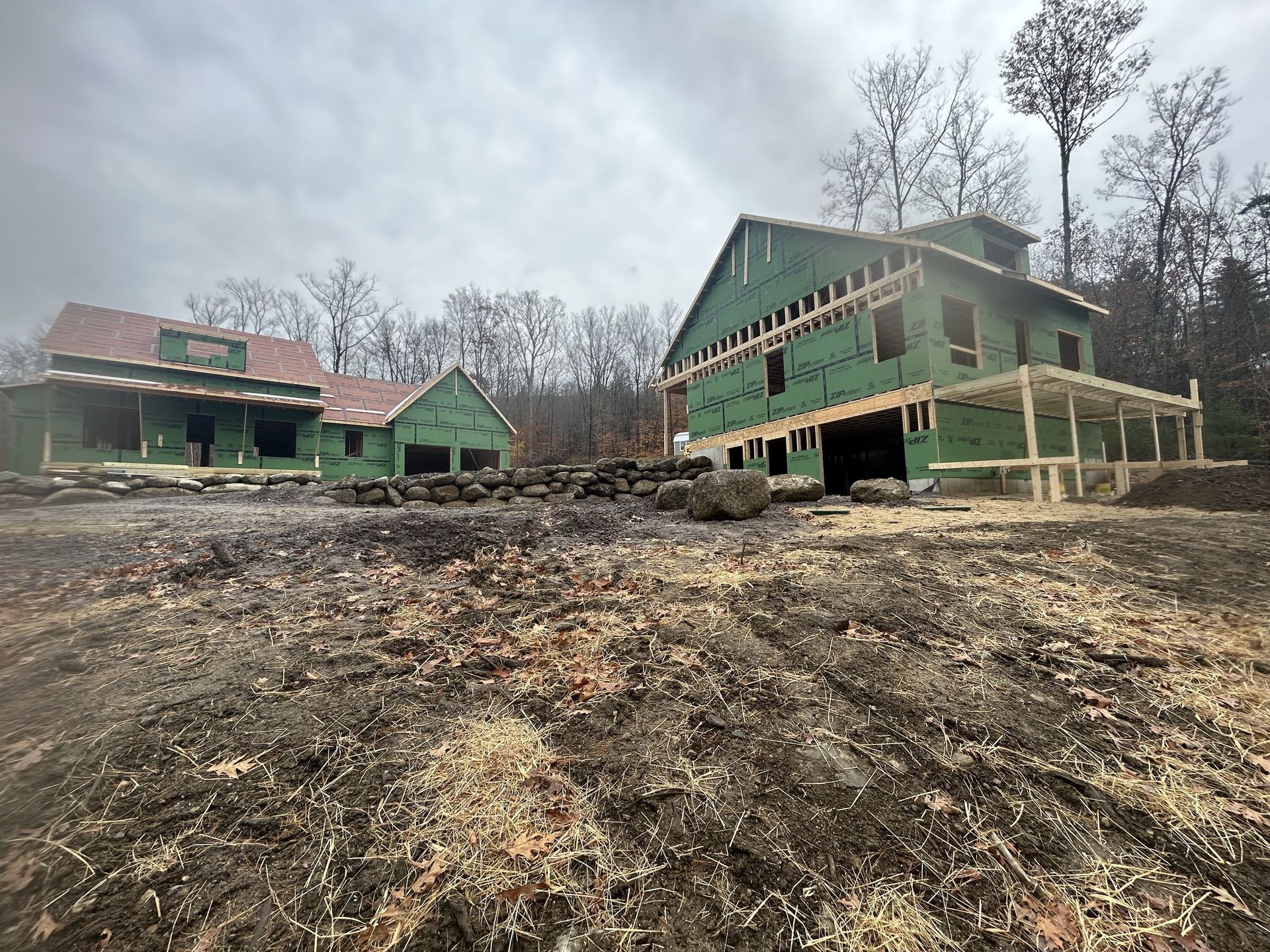 A large house is being built in the middle of a field.