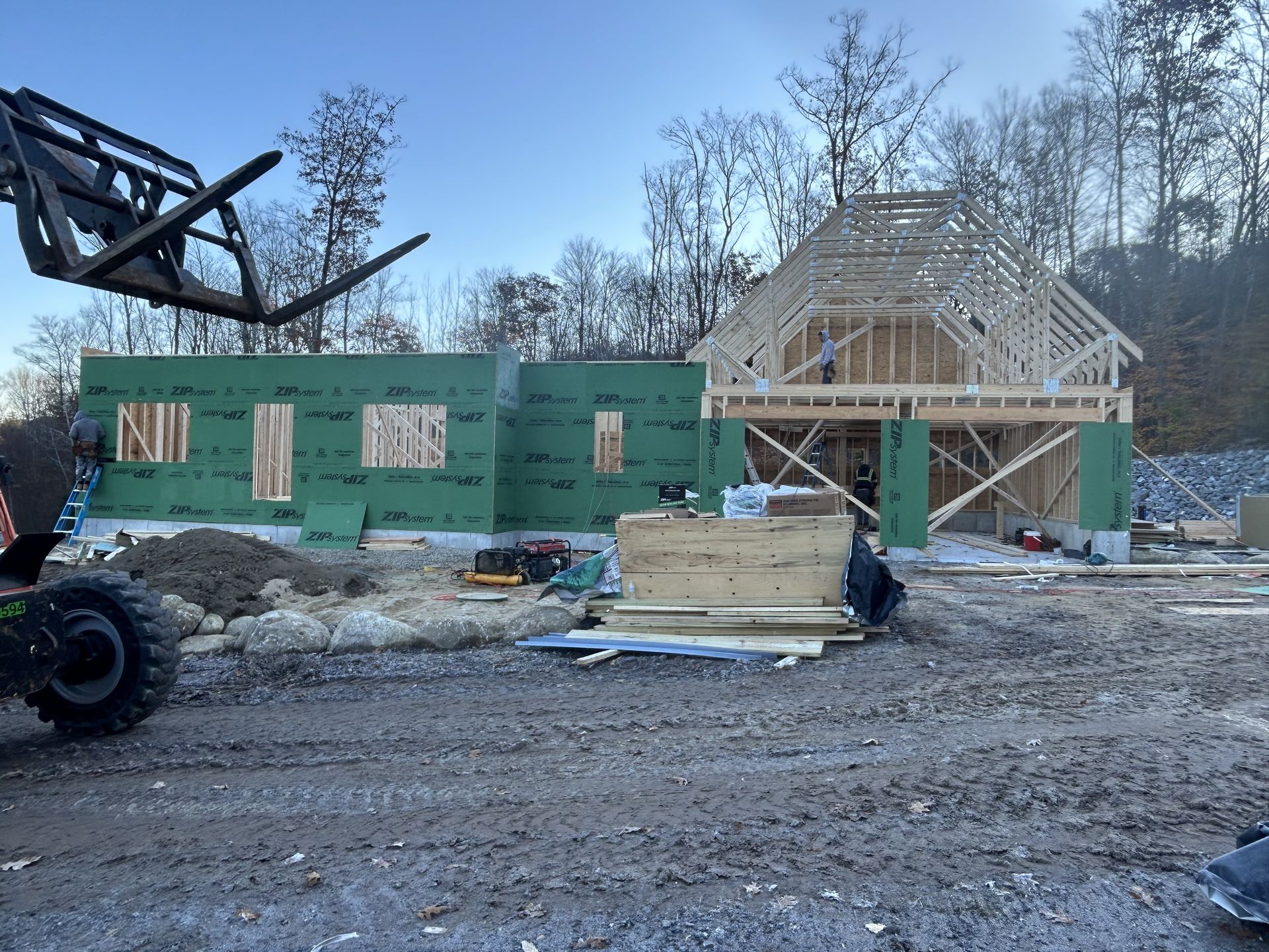 A large house is being built in a dirt field.