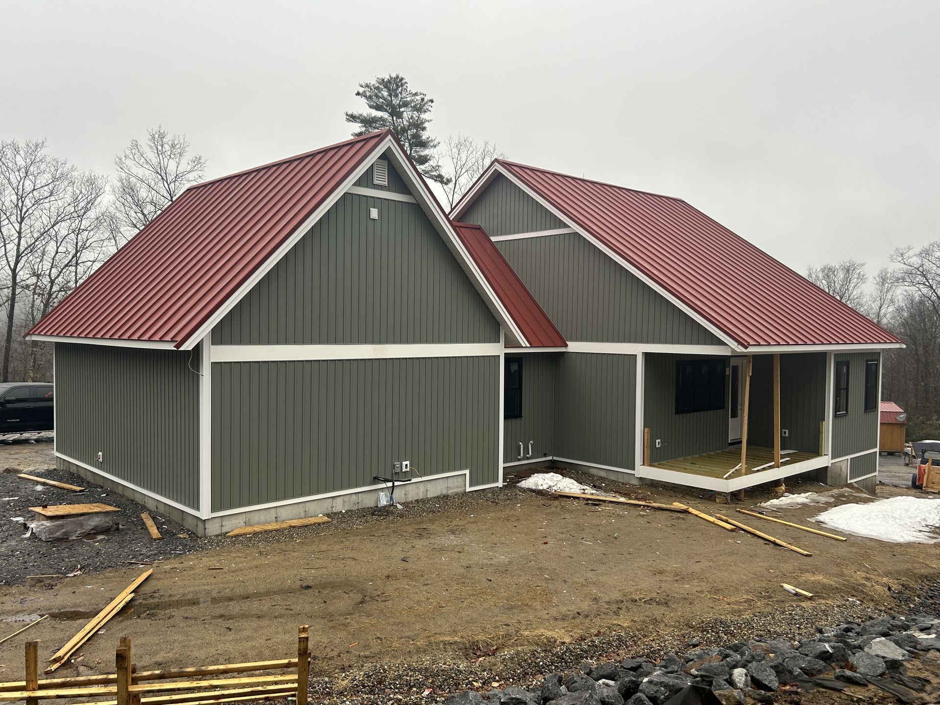 A green house with a red roof is being built