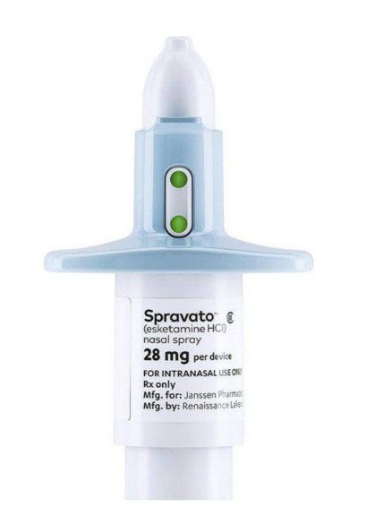 Spravato nasal spray device with white cap, light blue handle, and green indicators.