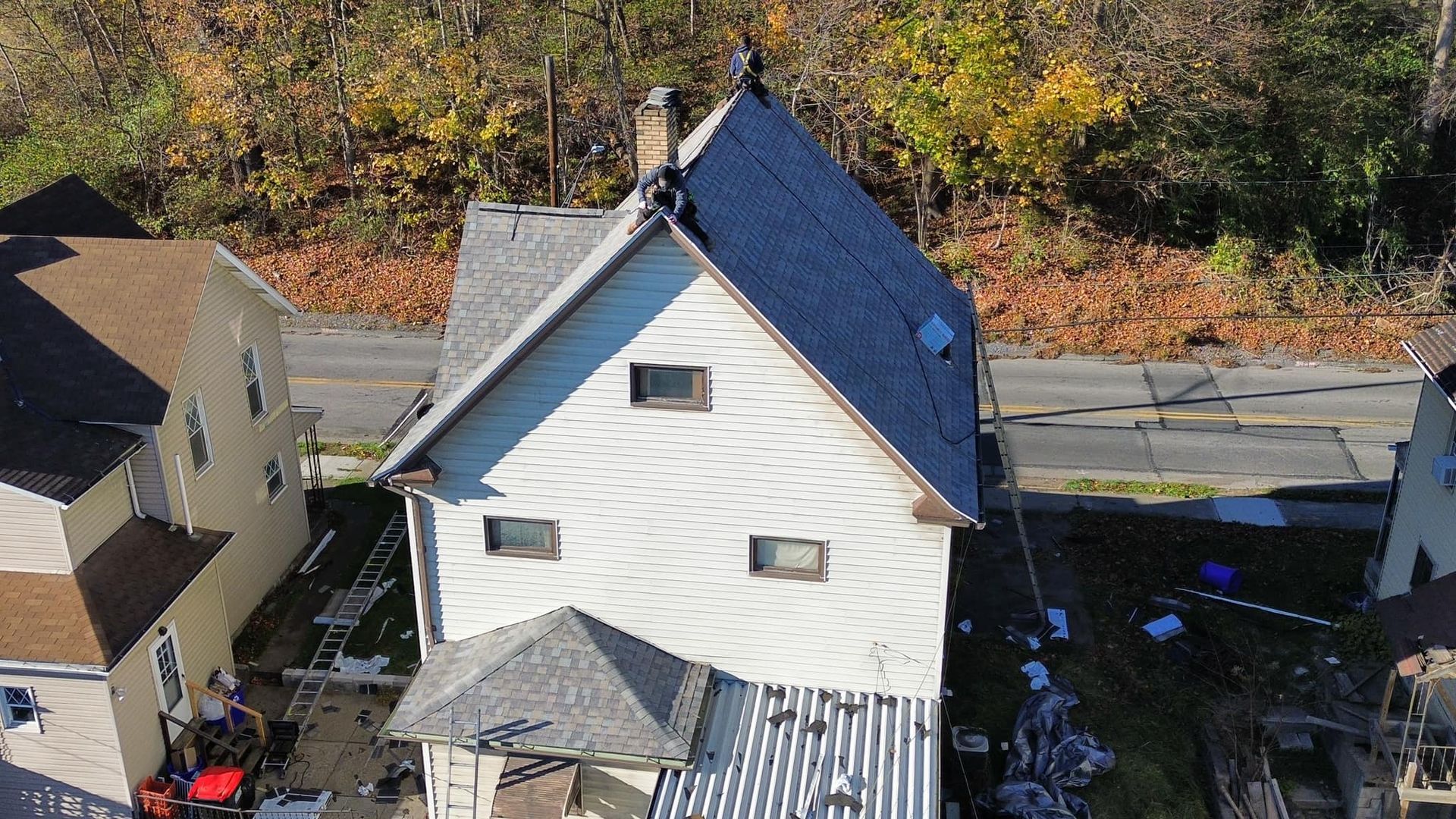 An aerial view of a house with a blue roof.