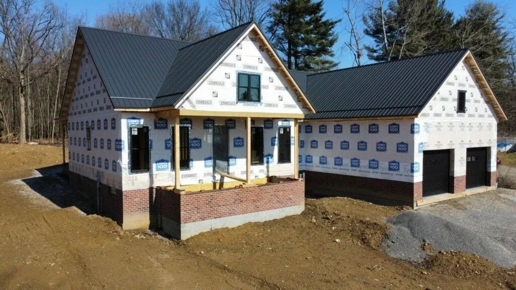 A house that is being built with a black roof