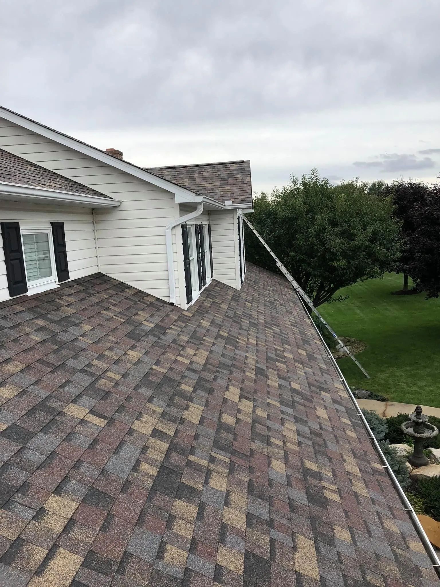 A house with a roof that has shingles on it.