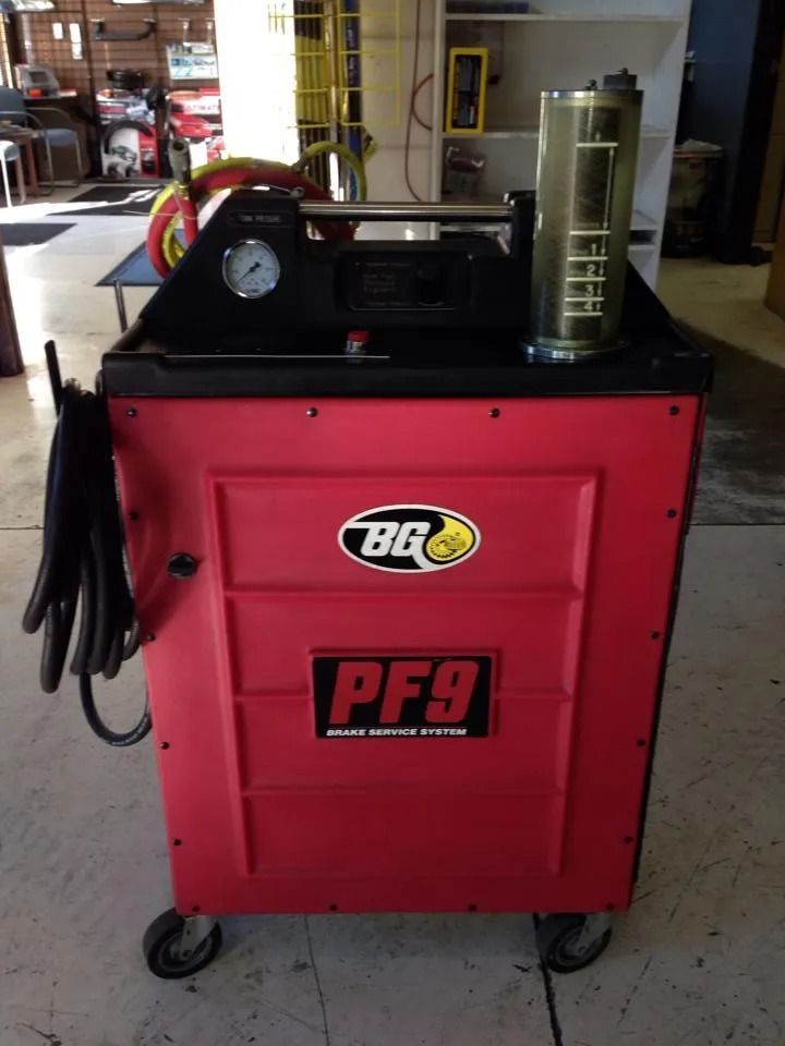 Red BQ PF9 brake fluid exchange system machine on wheels with pressure gauge and fluid reservoir.