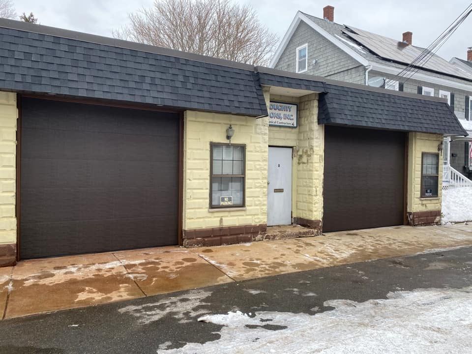 A building with two garage doors on the side of it.