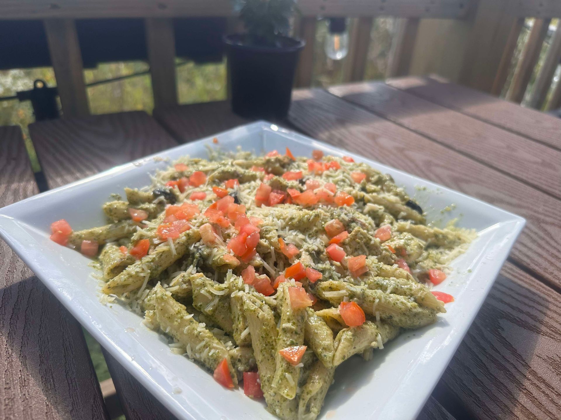 A white plate topped with pasta and meat on a table.