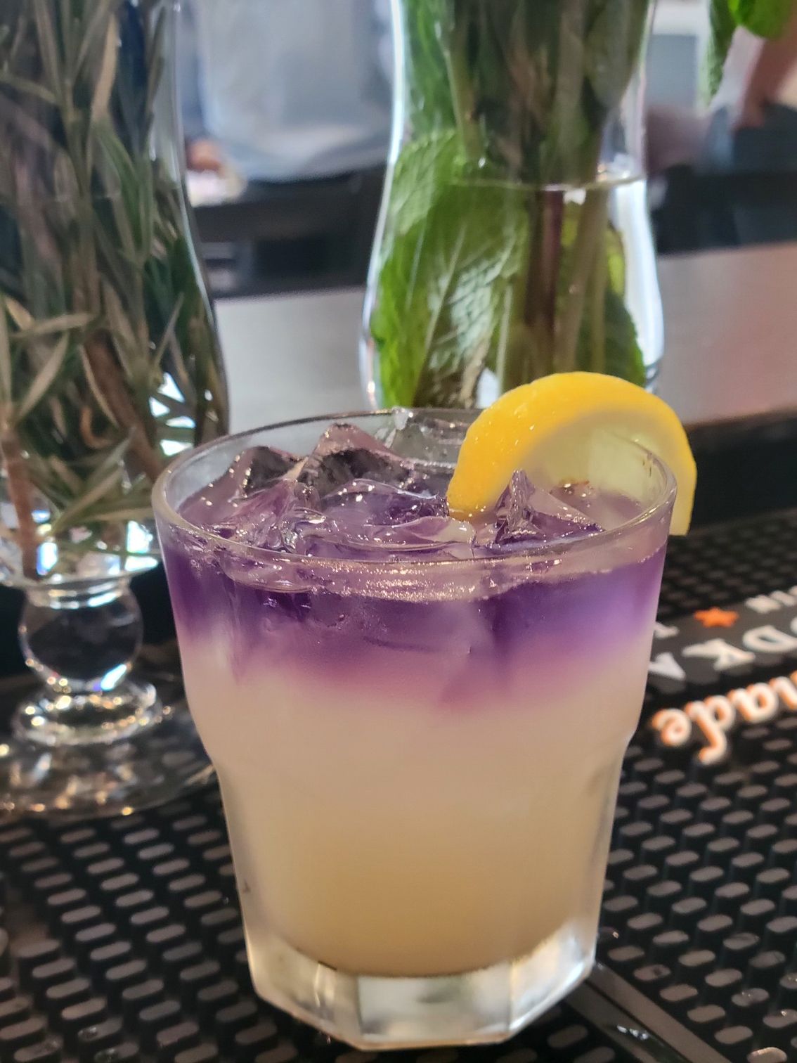A purple and white drink with a lemon slice on top