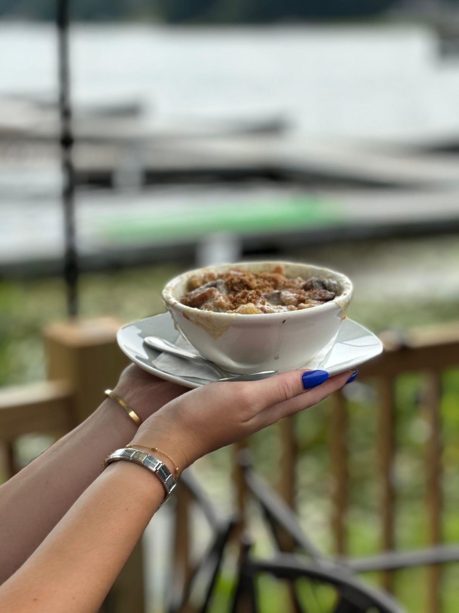 A woman is holding a bowl of cereal in her hand.