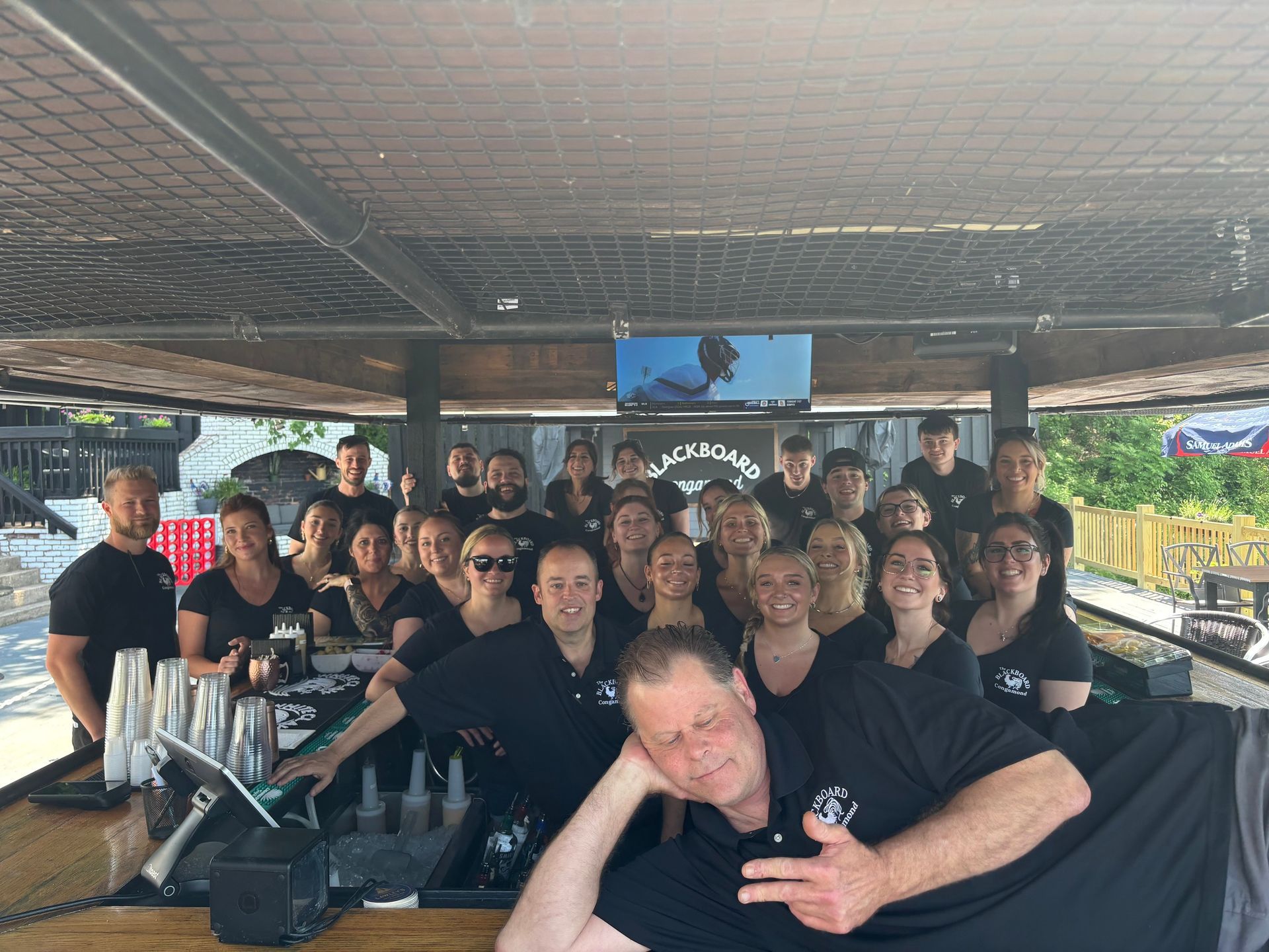 A group of people posing for a picture at a bar