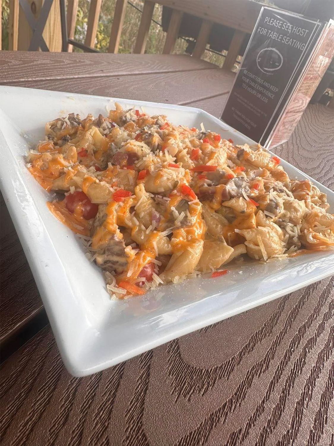 A plate of food is on a table next to a menu.
