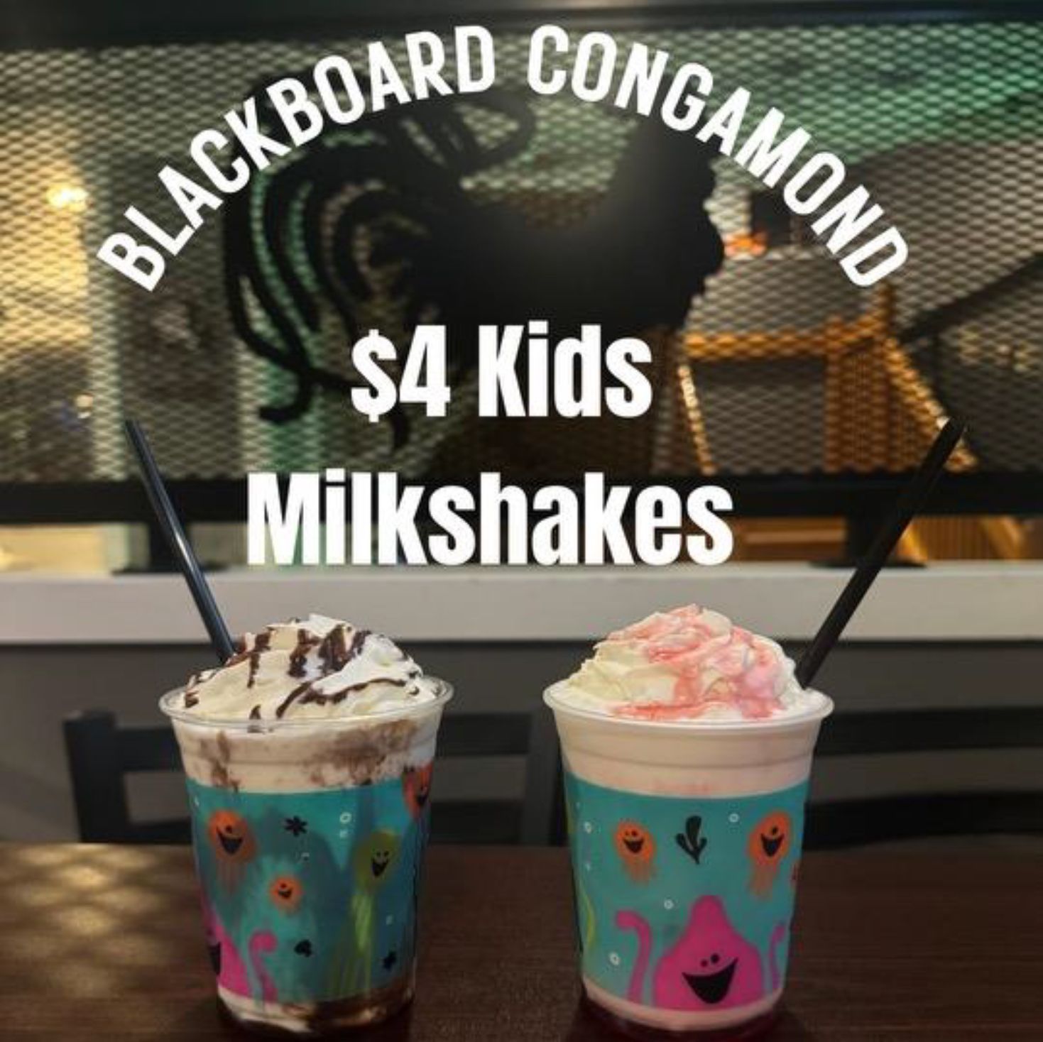 Two kid's milkshakes on a table.