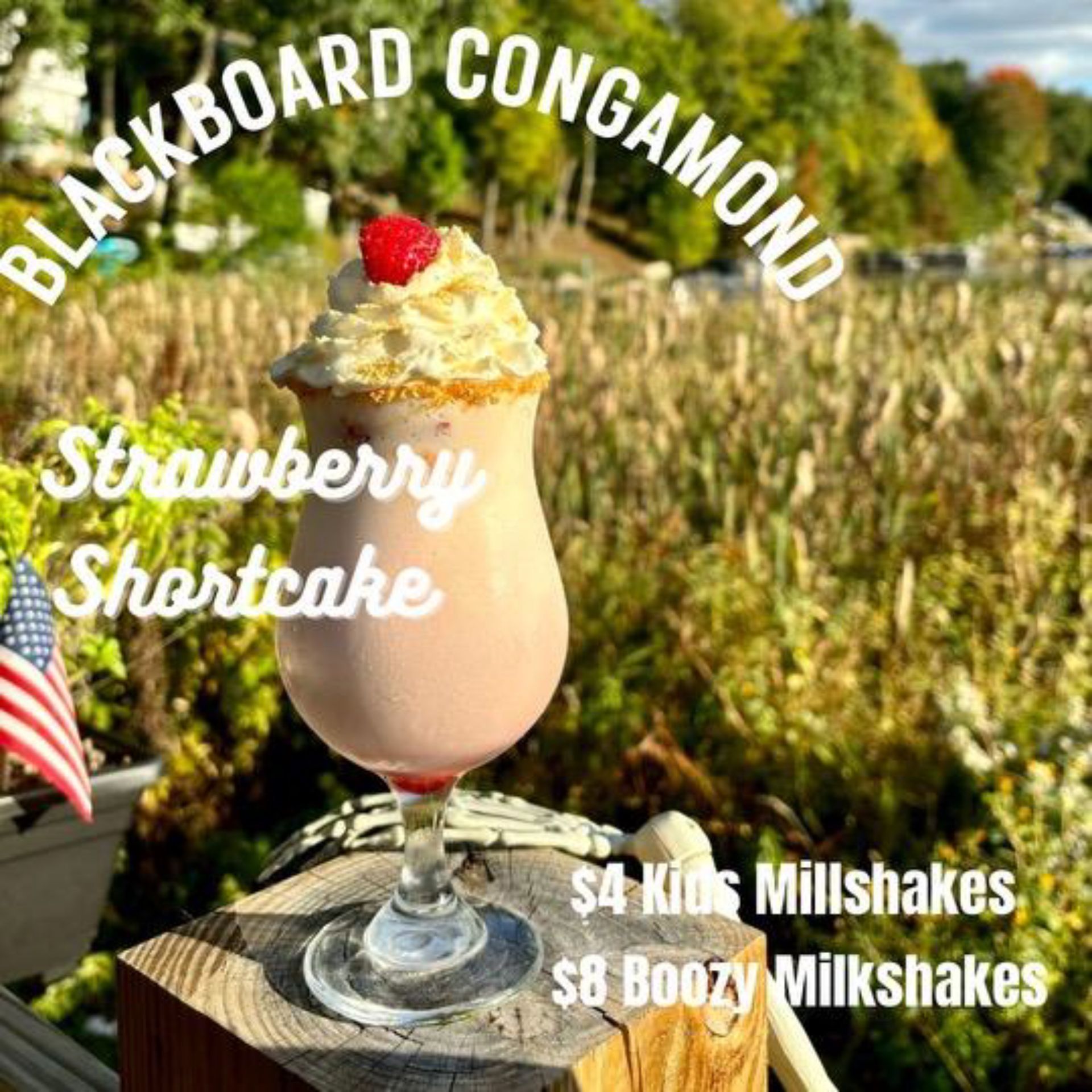 A strawberry shortcake milkshake with whipped cream and a cherry on top.