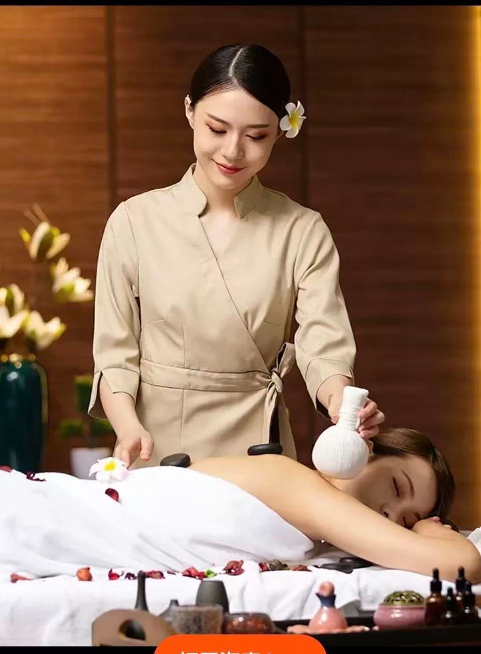 Woman receiving spa treatment; therapist applies hot stone and herbal compress in a serene setting.