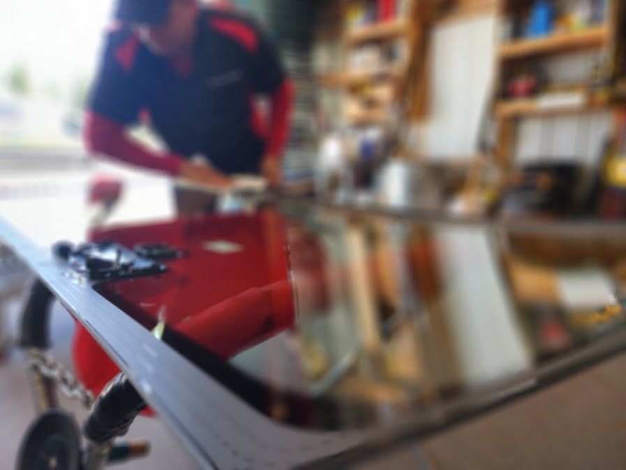 A blurry picture of a man cutting a piece of glass