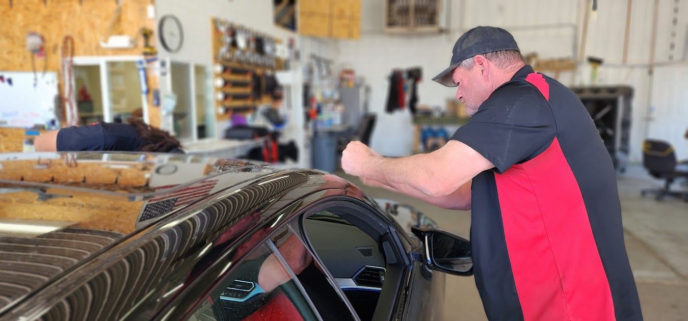 A man is working on a car in a garage.