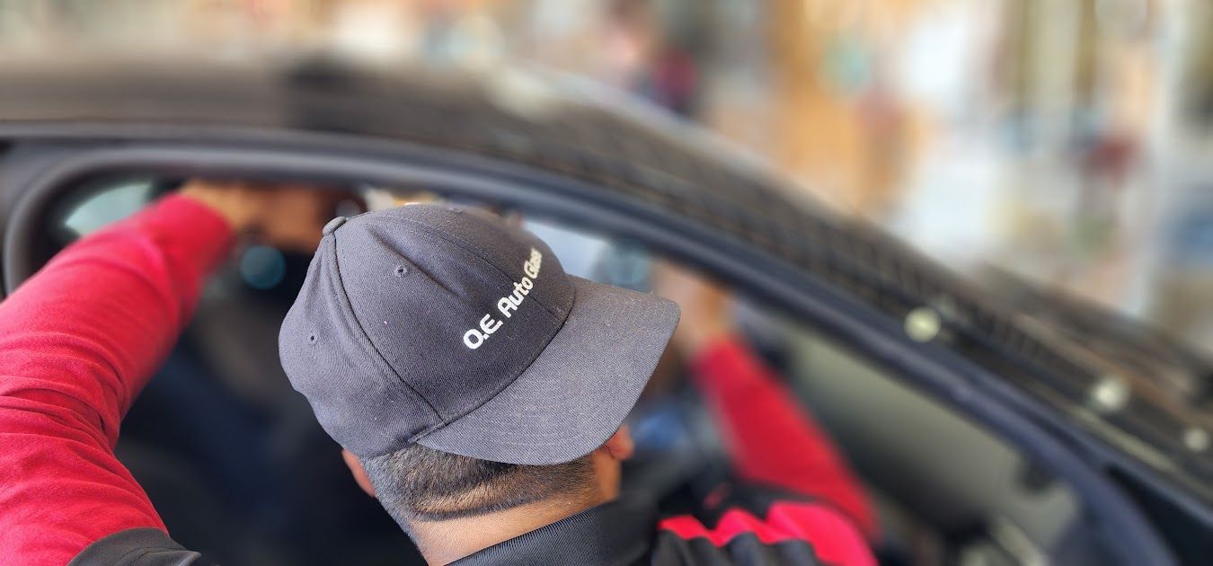 A man wearing a hat is sitting in a car.